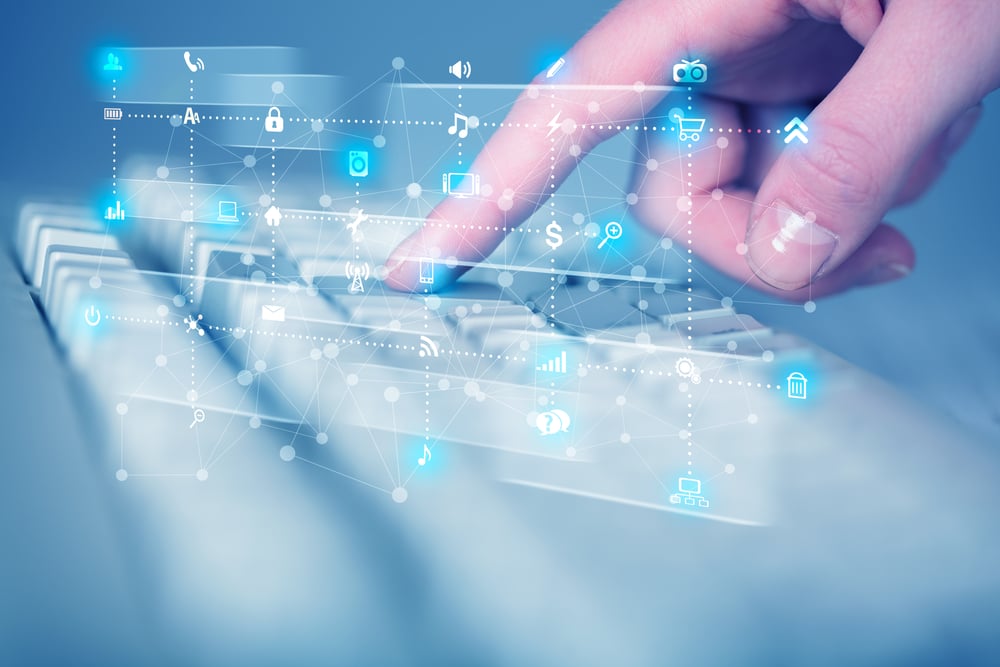 Hand pressing keyboard with high tech media icons and symbols