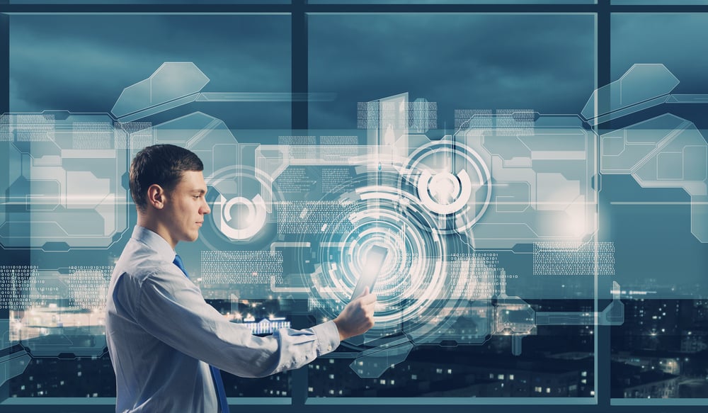 Young businessman with tablet in hands against digital background