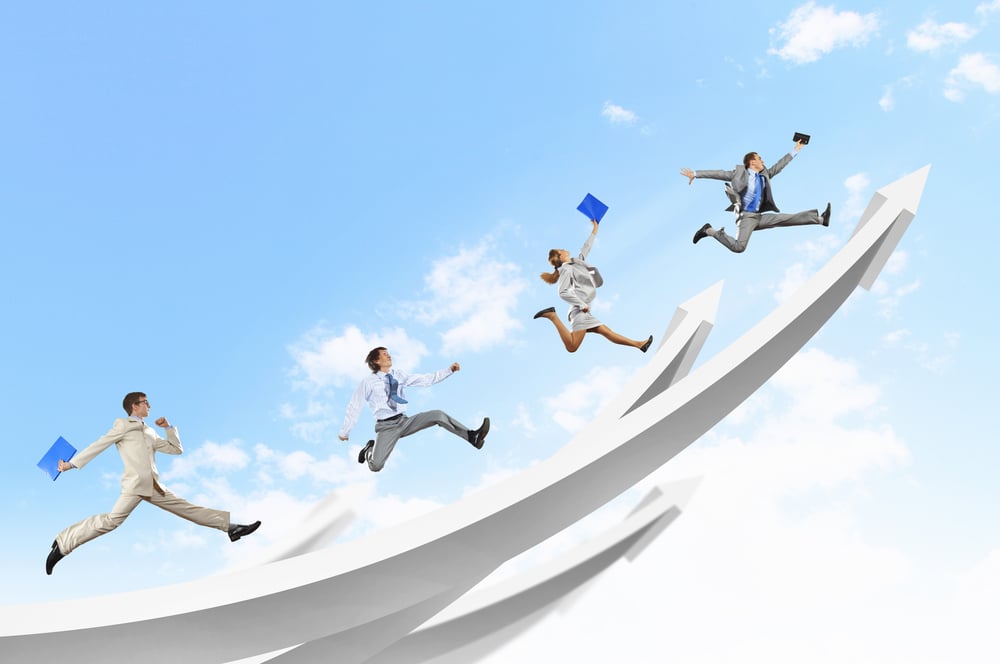 Young businesspeople jumping on white arrows. Growth concept